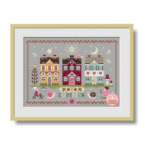 May include: Framed cross-stitch art featuring three colorful houses with intricate details. The houses are in shades of yellow, red, and blue, with decorative elements like flowers, snails, and the word "SUMMER". The artwork is set against a gray background.
