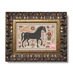 May include: A framed cross-stitch depicting a black horse with a rider, surrounded by floral and foliate motifs in red, gold, and green. The artwork is in a decorative gold frame.
