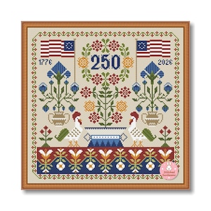 May include: A framed cross-stitch design featuring the American flag, floral patterns, and the numbers "250" and dates "1776" and "2026". The design includes two roosters, blue flowers, and a decorative border. The overall color scheme is beige, red, blue, and green.