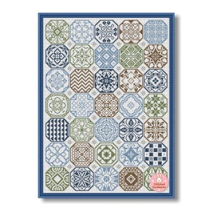 May include: A framed cross-stitch sampler featuring a grid of octagonal tiles. Each tile showcases a unique geometric pattern in shades of blue, green, and brown. The piece is framed in a dark blue border, with the text "Stitched Sunbeams" in the lower right corner.