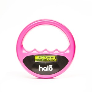 May include: A bright pink Halo Scanner device with a circular handle and a black rectangular base. The device has a small screen displaying text and a serial number. The word "halo" is printed in white on the base.
