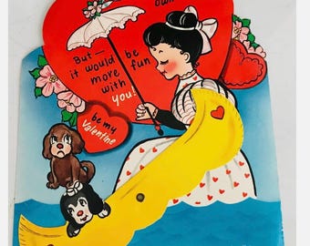 Grote, gestanste, mechanische Valentijnskaart uit de jaren 1950 in de vorm van een kano, nieuw in de verpakking (NOS) van American Greetings.