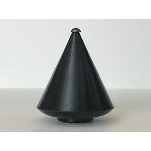 May include: A black spinning top with a silver metal tip.