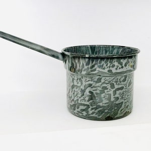 May include: A gray enamel saucepan with a long handle. The saucepan has a speckled pattern.