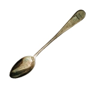 May include: A silver spoon with a rounded bowl and a long handle. The handle has the word "WALL" engraved on it.