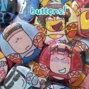 May include: A collection of circular pin-back buttons featuring colorful cartoon illustrations of characters with paw-like hands and burger-themed elements. The text "Forsaken paw buttons!" is overlaid in light blue on the image.