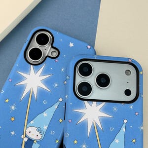 May include: Two blue phone cases with a whimsical design. The cases feature a repeating pattern of stars and a cartoon character holding a star wand. The cases have cutouts for the phone's camera and buttons.