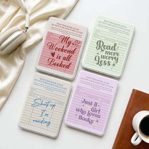 May include: Four rectangular metal tins designed like vintage library checkout cards. The pink tin reads My Weekend is all Booked, the green tin reads Read more worry Less, the blue tin reads Shut up I'm reading, and the purple tin reads Just A Girl who loves Books.
