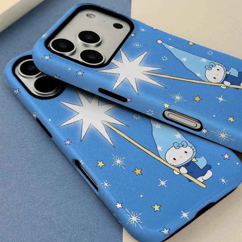 May include: Two blue phone cases with a whimsical design featuring a cartoon character in a wizard hat, holding a wand, and surrounded by stars. The cases have a black border and are designed to fit a smartphone.