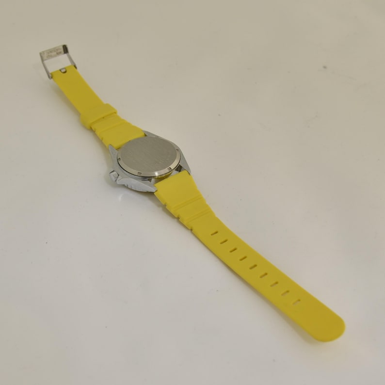 Vintage travel lover watch showing a map of Europe with bright colors, destination graphics, and rotating airplane feature