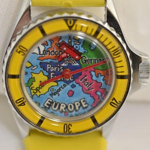Vintage Europe travel watch with rotating red airplane seconds hand and colorful map dial featuring European landmarks and countries