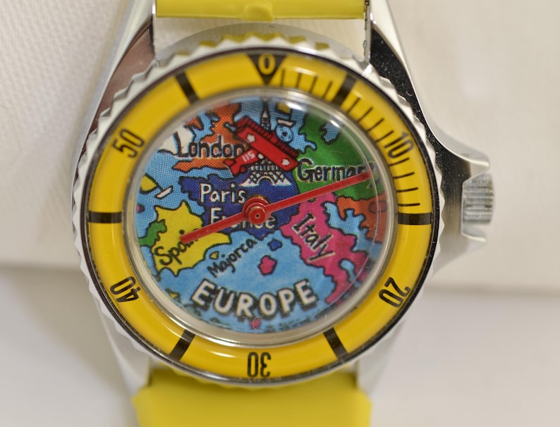 Vintage Europe travel watch with rotating red airplane seconds hand and colorful map dial featuring European landmarks and countries
