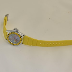 1980s novelty Europe map wristwatch with playful red airplane hand, travel theme artwork, and collectible tourist souvenir appeal