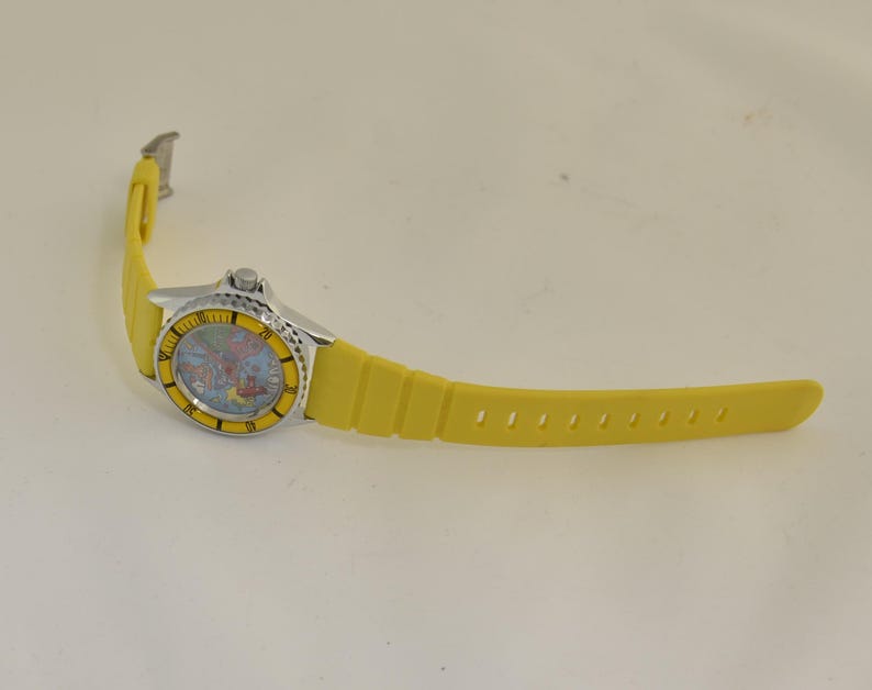 1980s novelty Europe map wristwatch with playful red airplane hand, travel theme artwork, and collectible tourist souvenir appeal