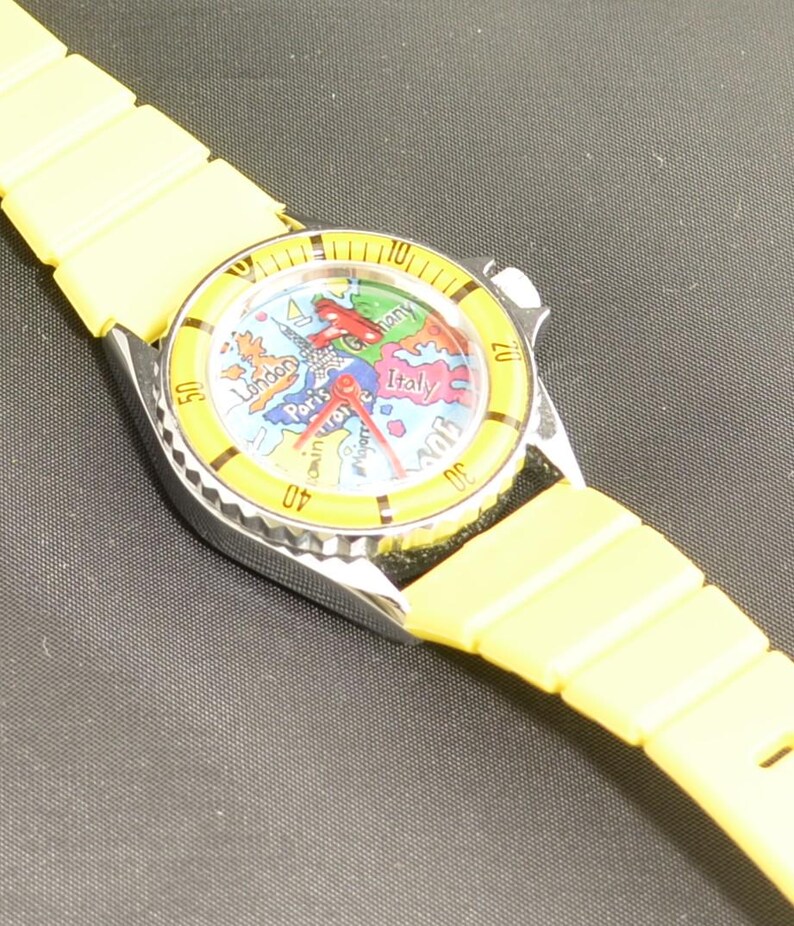 Colorful vintage European travel watch featuring country map graphics, analog movement, and unique airplane seconds hand detail