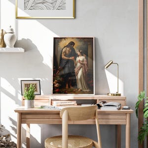 May include: A framed rectangular wall art print depicting a classical scene of a man in a dark cloak and a woman in a white gown exchanging a red apple, surrounded by flowers and architectural columns in a warm, dimly lit setting.