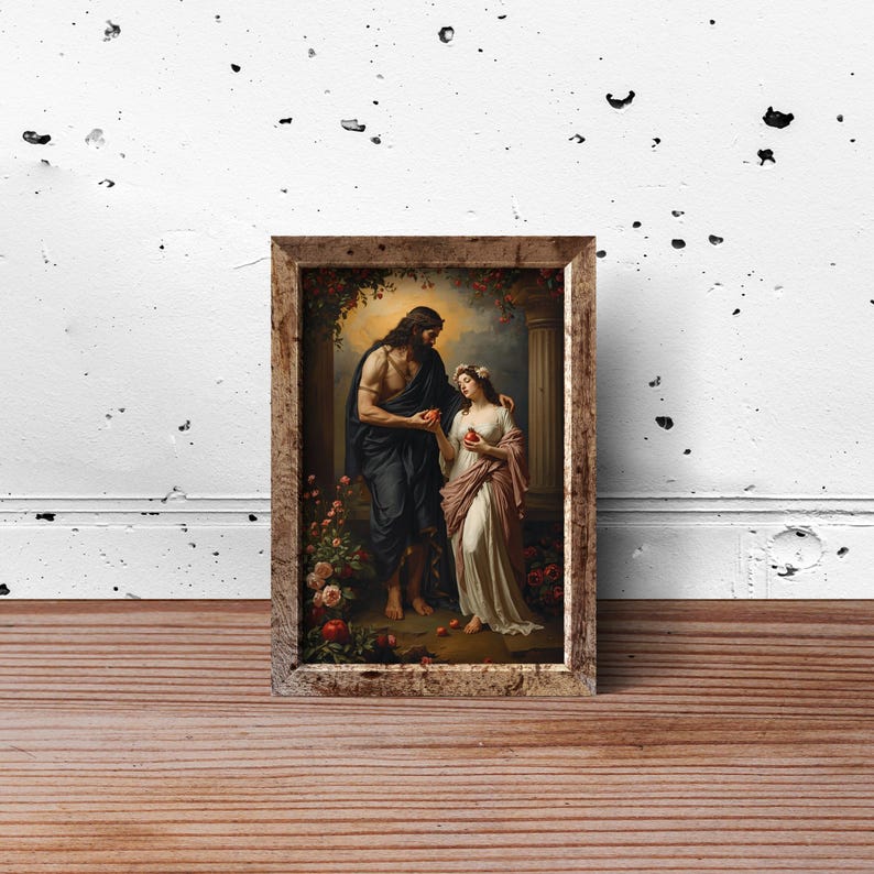 May include: A framed rectangular wall art print depicting a man with long dark hair in a dark robe and a woman in a white and pink gown standing between stone columns. Both figures hold red apples amidst a setting with flowers and foliage.