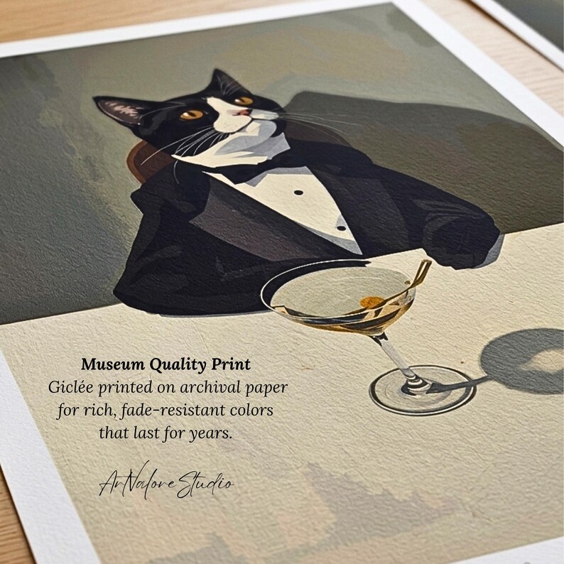 May include: A rectangular art print featuring a black and white tuxedo cat wearing a black suit jacket and bow tie, sitting beside a martini glass. The text reads: Museum Quality Print, Gicl&eacute;e printed on archival paper for rich, fade-resistant colours that last for years. ArNalore Studio.