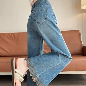 Blue Flared Jeans with Floral Embroidered Hem