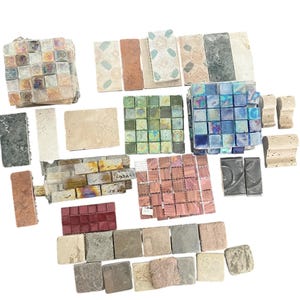 May include: A collection of various mosaic tiles in different shapes, sizes, and colors. The tiles include square, rectangular, and irregular shapes, with colors ranging from iridescent to earthy tones. Some tiles are arranged in small groupings.