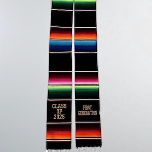 May include: A graduation stole with a black base and colourful stripes of pink, green, orange, and blue. The stole has the text "CLASS OF 2025" and "FIRST GENERATION" embroidered in gold.