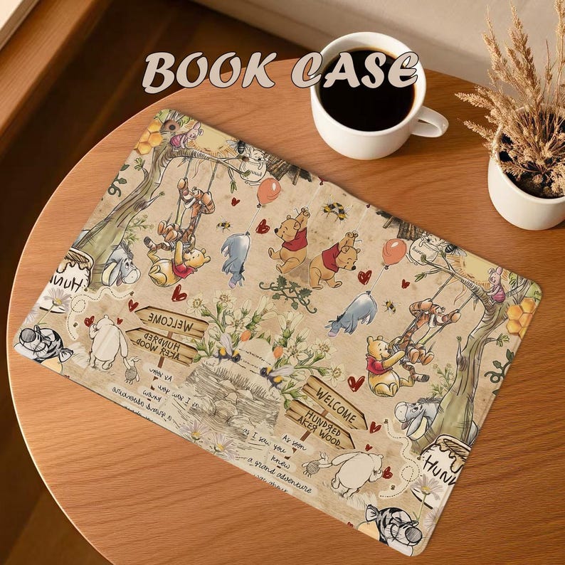 May include: A rectangular beige book case featuring a whimsical illustration of Winnie the Pooh and friends. The design includes characters, balloons, and the text "BOOK CASE", "WELCOME Hundred Acre Wood", and other phrases.