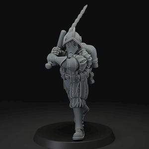 May include: A gray figurine of a figure in historical garb, including a helmet, gas mask, and puffy pants. The figure is holding a club and a bladed weapon, posed as if in motion. The figurine is on a black circular base.