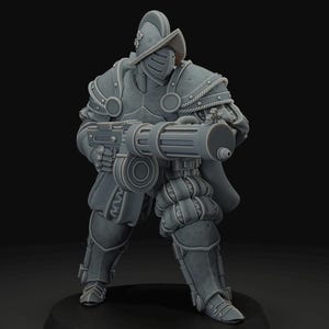 May include: A gray miniature figurine of a soldier in ornate armor, holding a large weapon. The soldier wears a helmet and has a cape. The figure is standing on a black circular base.