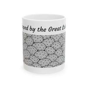 May include: White ceramic mug with a black and white pattern of rounded shapes. The mug has the text "ped by the Great La" printed in black on the top.