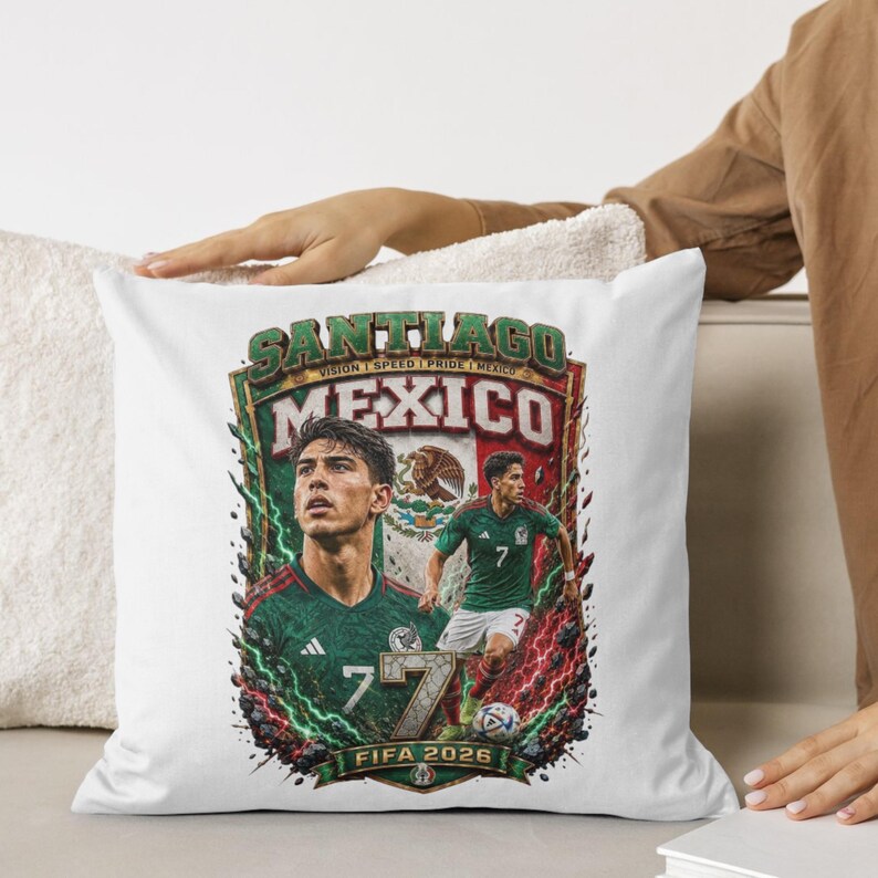 May include: A white square throw pillow featuring a graphic print of a soccer player in a green jersey with the number 7. The design includes the text SANTIAGO, MEXICO, and FIFA 2026, along with a Mexican flag emblem and lightning effects.
