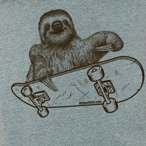 May include: A brown sloth with a toothy grin rides a skateboard with black wheels. The skateboard has a worn wooden deck with a white logo that reads "MyNextShirt.com".