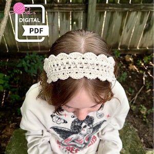 May include: A cream-colored crochet headband with a scalloped edge is worn on a person's head. The image also shows a white sweatshirt with a graphic of an angel and the text "DE". The image includes a "DIGITAL PDF" graphic.