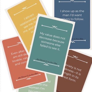 May include: A collection of affirmation cards from the Love Harvest collection. The cards are rectangular with rounded corners and feature inspirational quotes in white text on various colored backgrounds, including yellow, blue, and green.