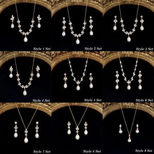 May include: Nine jewelry sets featuring gold-tone chains and earrings with clear marquise-cut crystals and white teardrop pearls. Each set is labeled Style 1 Set through Style 9 Set, showcasing various arrangements of leaf-shaped crystal motifs.