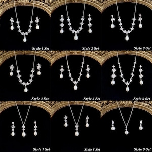 May include: A collection of nine jewelry sets, each featuring a silver-toned necklace and matching drop earrings with clear stones and white pearls. Each set is labeled Style 1 Set through Style 9 Set, showcasing various leaf-inspired designs.