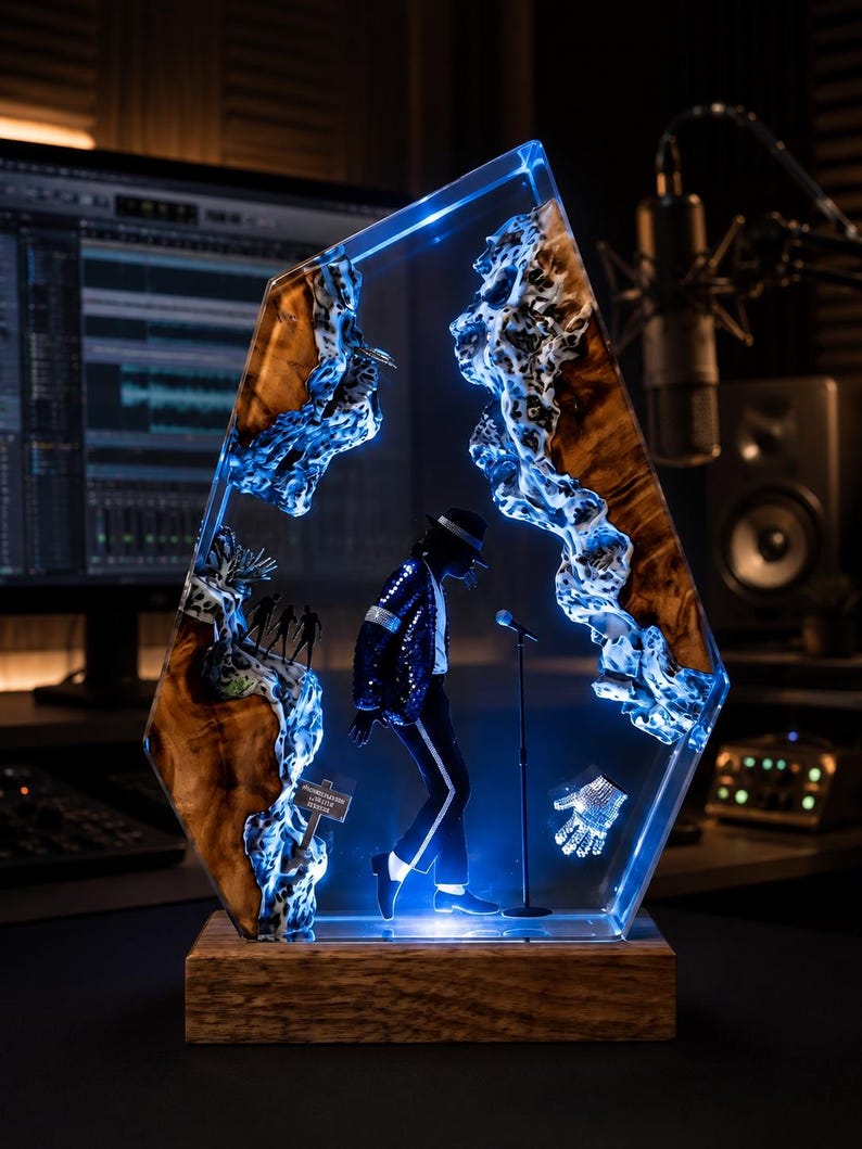 May include: A decorative resin and wood sculpture featuring a miniature figure of a performer in a black suit and fedora standing at a microphone. The piece includes a glowing blue light effect, a small sign, and a sparkling glove, all set on a wooden base.