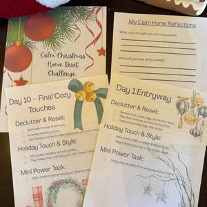 May include: A collection of printed papers with holiday-themed text and illustrations. The papers include titles like "Calm Christmas Home Reset Challenge" and "Day 1: Entryway." Decorative elements include ornaments, stars, and a wreath. The overall theme is home organization and holiday decor.