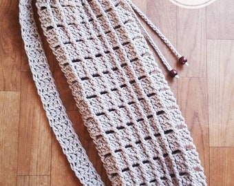 May include: A crocheted yoga mat bag with a drawstring closure and a long strap. The bag is beige and has a simple, open-weave pattern. The strap has wooden beads at the end. The text "CROCHET PATTERN INSTANT PDF DOWNLOAD" is visible in the upper right corner of the image.