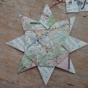 May include: A star-shaped ornament made from a folded map of Virginia. The map shows the area around Kingsport, Tennessee. The ornament has a metal ring at the top.