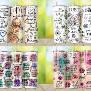 May include: A collection of stainless steel tumblers with various inspirational quotes and floral designs. The tumblers feature phrases like "Breathe," "Make Magic," and "I Am Confident." Each tumbler has a straw and a white lid.