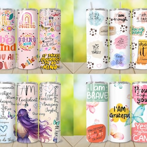 May include: A collection of insulated tumblers with various inspirational quotes and designs. The tumblers feature floral patterns, rainbows, butterflies, and positive affirmations like "Be Kind," "I Am Brave," and "Make it Happen."