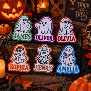 May include: Six embroidered ghost patches featuring different designs and names: James, Oliver, Olivia, Sophia, Henry, and Amelia. Each white ghost has a colored border and text, including accessories like sunglasses, a hat, and a water bottle.