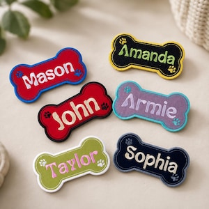 May include: Six bone-shaped fabric patches with embroidered names and paw prints. The patches are in red, black, purple, and green, featuring the names Mason, Amanda, John, Armie, Taylor, and Sophia stitched in contrasting thread colors.