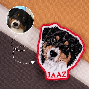 May include: Embroidered patch featuring a dog's face with black, brown, and white fur, outlined in red. The name "JAAZ" is embroidered in white at the bottom. A circular photo of the dog is in the upper left corner.