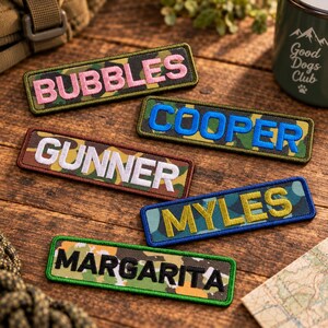 May include: Five rectangular embroidered patches with camouflage backgrounds. The patches feature the names BUBBLES in pink, COOPER in blue, GUNNER in white, MYLES in yellow, and MARGARITA in black, each with a matching colored border.