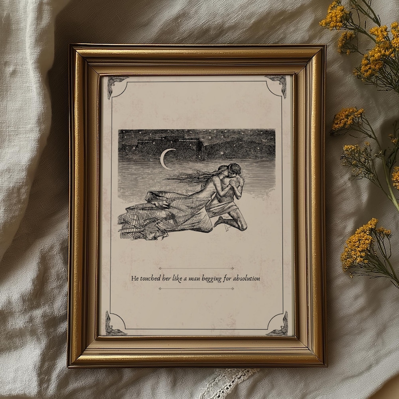 May include: A framed print with a gold-colored frame. The artwork is a black and white illustration of two figures embracing under a crescent moon and starry night sky. The text at the bottom reads, "He touched her like a man begging for absolution."
