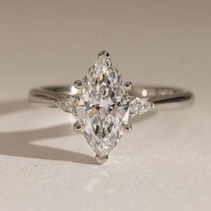 Marquise Cut Three Stone Ring, 1 to 3 CT Marquise Lab Grown Diamond Hidden Halo Engagement Ring, Side Pear Diamond Trilogy Ring For Women