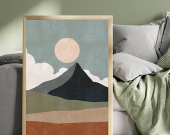 May include: Abstract art print featuring a mountain landscape with a large sun and clouds. The color palette includes shades of blue, green, brown, and orange. The artwork is framed in a gold-colored frame, suitable for home decor.