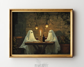 May include: A framed wall art print depicting two white ghost figures draped in sheets sitting at a wooden table. They are having a candlelit dinner with a wine bottle and two glasses. The scene is set against a stone wall with hanging lanterns.