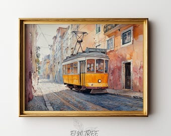 May include: Watercolor print of a yellow tram traveling down a cobblestone street in a European city. The tram is framed in a gold-colored frame. The buildings are painted in warm tones of orange and peach.